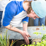 student, Holden Knapp, rubs soil between his hands
