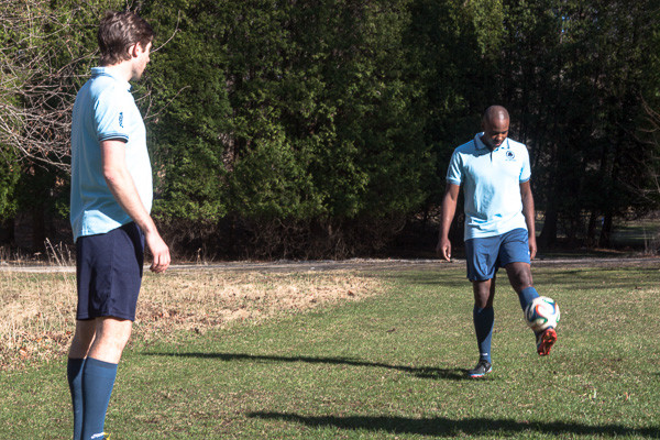 Konx Cameron practices soccer with team mate