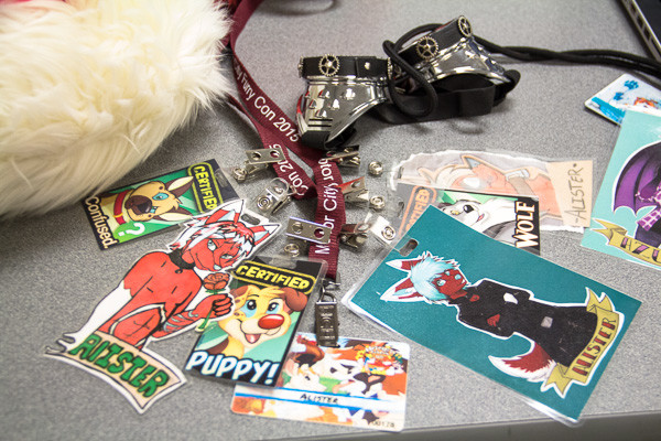 collection of various badges to local conventions