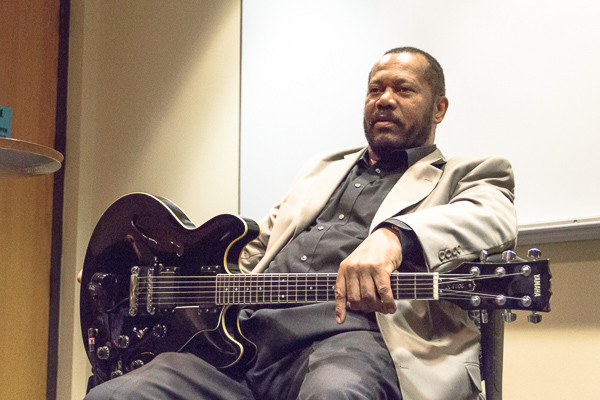 John E. Lawrence with his guitar