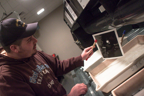 Doug Miller demonstrating proper techniques in the darkroom.