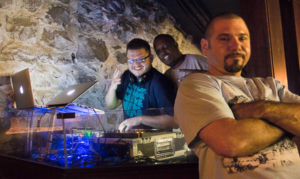 DJ booth with three men