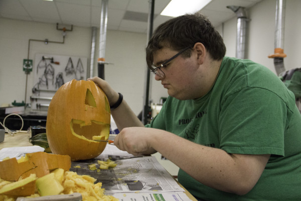 WCC student, Cameron Tripp carves a pumpkin