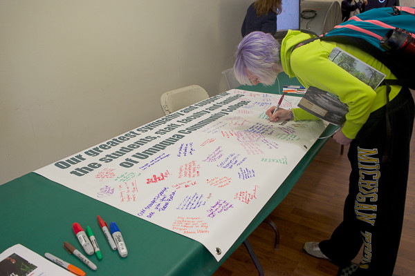 student signs a banner