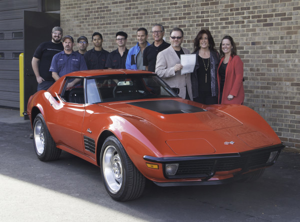 WCC students stand next a red corvette