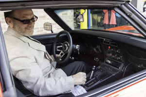 Dion Altadonne sit behind the wheel of a Corvette