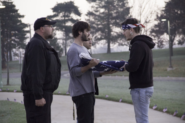 Four WCC veteran students fold a US flag