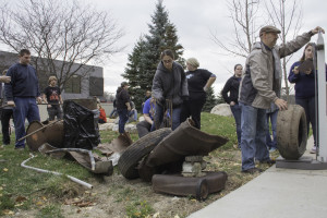 students weigh the trash they collected