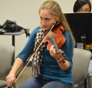 Juliana Patselas plays during a music club meeting