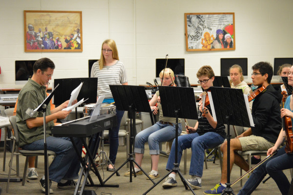 students play at a music club meeting