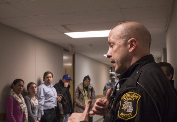 After the first scenario, Sgt. Keith Flores debriefs and talks to students about the dos and don’ts in certain situations like the given scenario. Andrei Pop | Washtenaw Voice