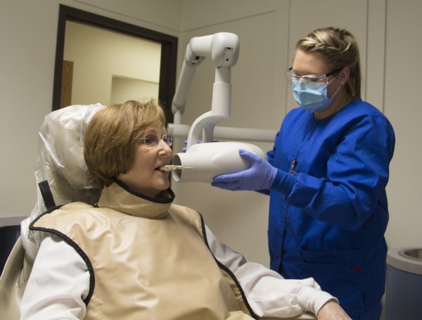 Student taking x-rays on a patient