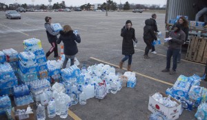 Several students helping gather water for Flint