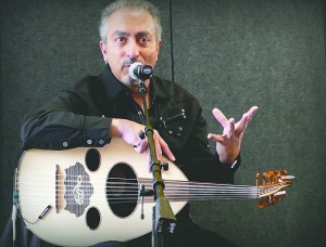 Victor Ghannam, with his oud, explaining the various scales used in Arabic music, at the Java Spot "Coffee House". Evans Koukios | Washtenaw Voice