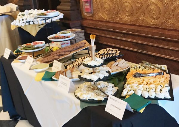 Cold platter display of cheeses, mixed vegetables, and cold meats