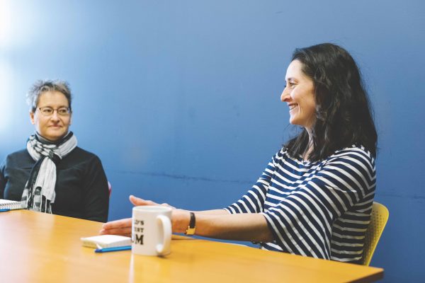 Markell Miller (right), Director of Community Food Programs at Food Gatherers, and Sara McDonnell, Communications Coordinator at Food Gatherers, discuss the upcoming potential shifts in SNAP funding and benefits that could affect Michigan residents.