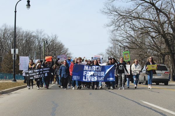 The many attendees, front and center, carried banners and posters to tell passersbys that they are “marching for their lives.” Photo by Michael Mishler