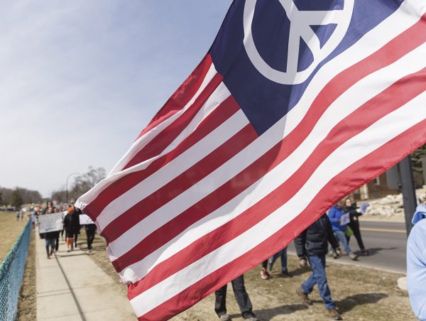 An American flag with the peace logo on it.