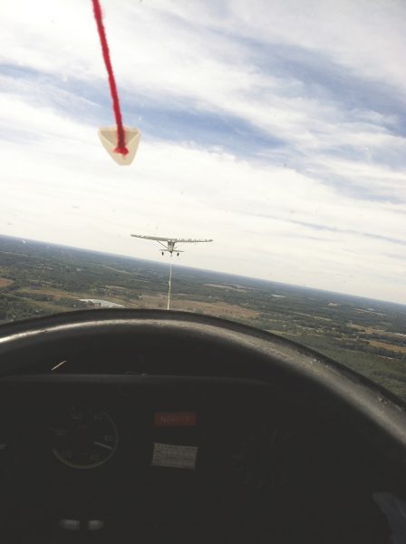 A WWII vintage plane tows a glider 2,500 feet above the ground.
