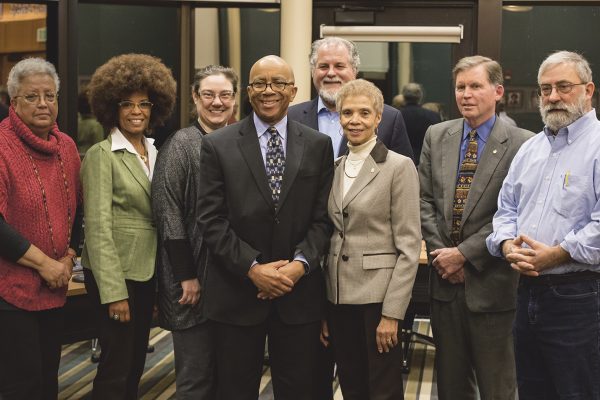 Damon Flowers, vice president of facilities (center) poses with the board of trustee members before his retirement earlier this year. Photo by Sara Faraj