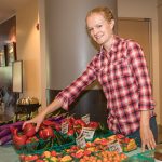 St. Joe's Farm Manager Amanda Sweetman arranges fresh produce at the St. Joe's Farmers Market
