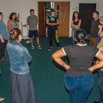 The directors and cast of Antigone warm up before rehearsal