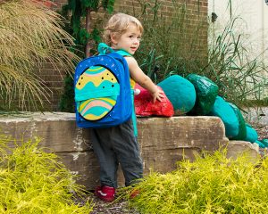 WCC student, Catherine Engstrom's, son plays with the colorful stone caterpillar outside of the WCC Childcare Center