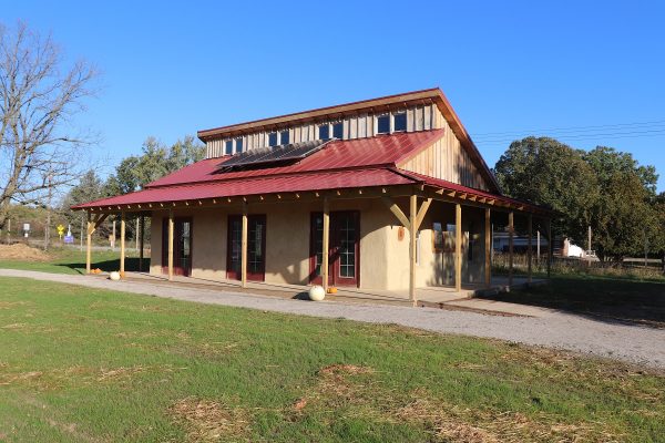 Straw bale buidling uses solar panels for sustainable energy.