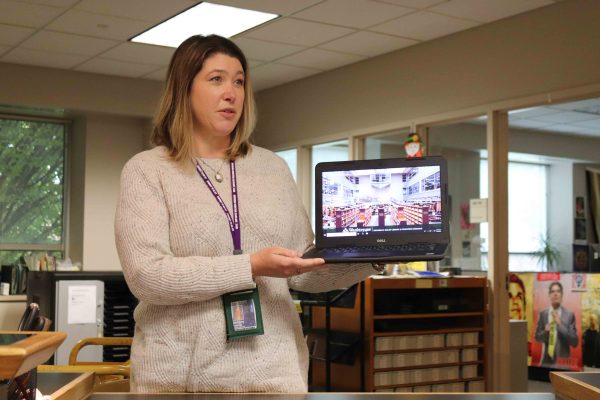 Director of access services for the Bailey Library, Bethany Kennedy, presents one of the 11 borrowable laptops. Josh Mehay | Washtenaw Voice
