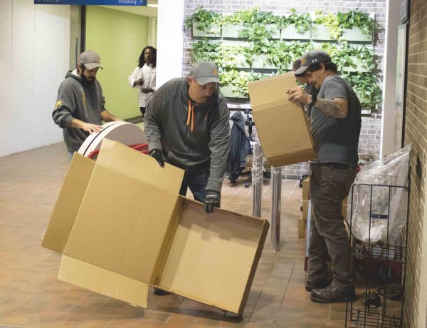 Workers unpack and set up new furniture in the T.I. building. Josh Mehay | Washtenaw Community College