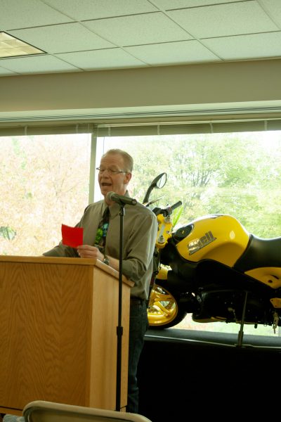 Host and English department head Tom Zimmerman reads Halloween-themed poetry from Edgar Allen Poe and Shakespeare during the open mic. Lilly Kujawski | Washtenaw Voice