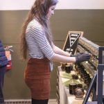 Erin Berger, owner of Bookend Candle Co., has been creating homemade candles since January of this year. Here, she arranges them for the fair. Find her store, Bookend Candle Co., on Etsy. Vardan Sargsyan | Washtenaw Voice