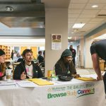 Zoey Mackey (left), 20, Richard Romanus, 26, and Martaveius Taylor, 25, greet those entering the Bailey Library. Sara Faraj | Washtenaw Voice