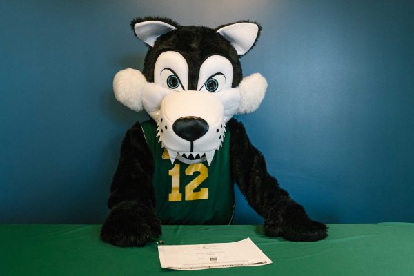 WCC mascot Alpha poses with a March Madness bracket. Sara Faraj | Washtenaw Voice