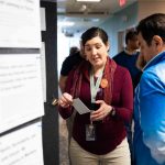Meghan Rose, one of the librarians that assisted students in finding a story to listen to at The Human Library, speaking with a student. Lily Merritt | Washtenaw Voice