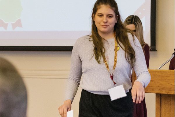 Lilly Kujawski accepting an award for second place in best news story at the MCCPA conference. Asia Rahman | Washtenaw Voice