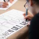 WCC students prepare for the Climate Strike by printing T-shirts and making posters. Eric Lee | Washtenaw Voice