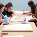 WCC students prepare for the Climate Strike by printing T-shirts and making posters. Eric Lee | Washtenaw Voice