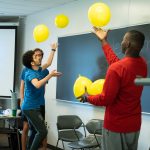 Students test coordination with a balloon toss game. Eric Le | Washtenaw Voice