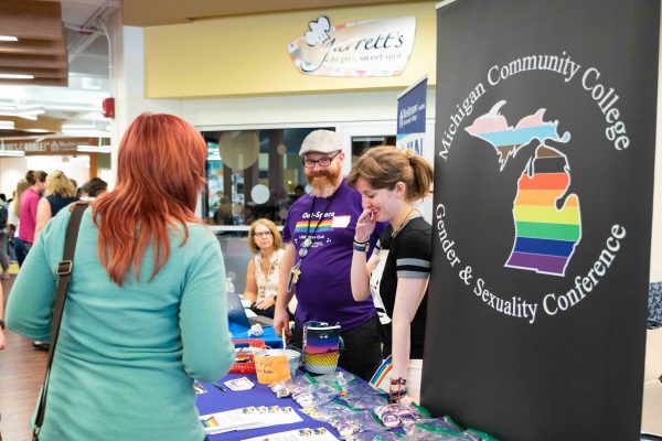 Out-Space representatives invite students to check out the Michigan Community College Gender and Sexuality Conference. Lily Merritt | Washtenaw Voice