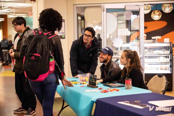 From left to right: Julio Roque, Martin Davalier, and Lama Dahglas share with students what the Pre-Med club has to offer. Lily Merritt | Washtenaw Voice