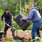 Julio Roque shovels holes for the new apple trees. Lily Merritt | Washtenaw Voice