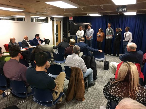 Pitchers stand before “Pitch Pit” judges in anticipation of learning which pitch won. Nicholas Ketchum | Washtenaw Voice