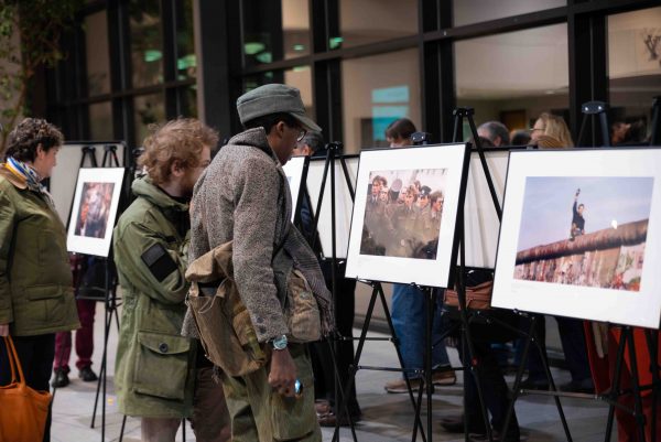 Event attendees had the opportunity to view a collection of photographs documenting the fall of the Berlin Wall. The photos will be on display in the second floor of the Student Center until Dec. 15. Lily Merritt | Washtenaw Voice