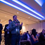 Nicholas Ketchum asks Marty Baron, executive director of the Washington Post, a question about the impact of satirical news on traditional journalism during the keynote speech Q&A.