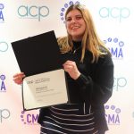 Lilly Kujawski poses with her honorable mention certificate for the Associated Collegiate Press/Ernie Pyle Reporter of the Year award.