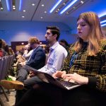 Lilly Kujawski and Vardan Sargsyan listening to Washington Post executive editor Marty Baron's keynote speech.