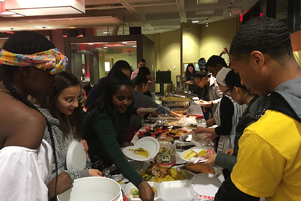 Students gather at the international Thanksgiving dinner to share a potluck-style meal together. Brian Babcock | Washtenaw Voice