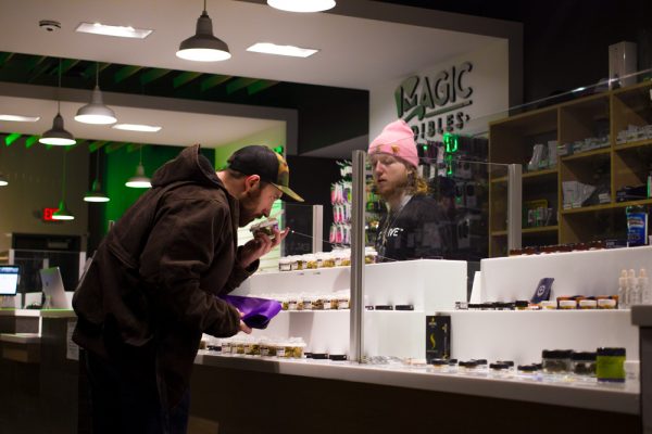 Medical marijuana patient Craig Stokes, left, and employee Jacob Samways discuss products at Exclusive Ann Arbor Provisioning, a local cannabis shop. Exclusive Ann Arbor is one of the first shops in Michigan licensed to make recreational marijuana sales starting Dec. 1. Vardan Sargsyan | Washtenaw Voice