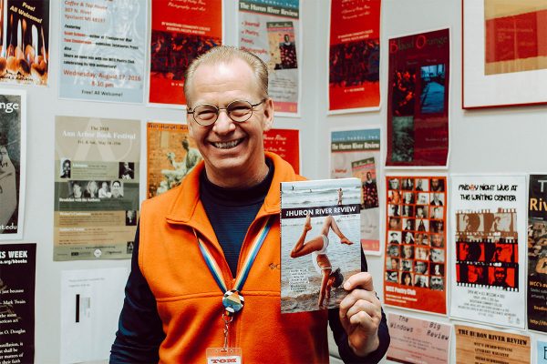 Editor of “Huron River Review” Tom Zimmerman shows off an edition of the literary journal. The deadline to submit for this year’s edition is Jan. 31.